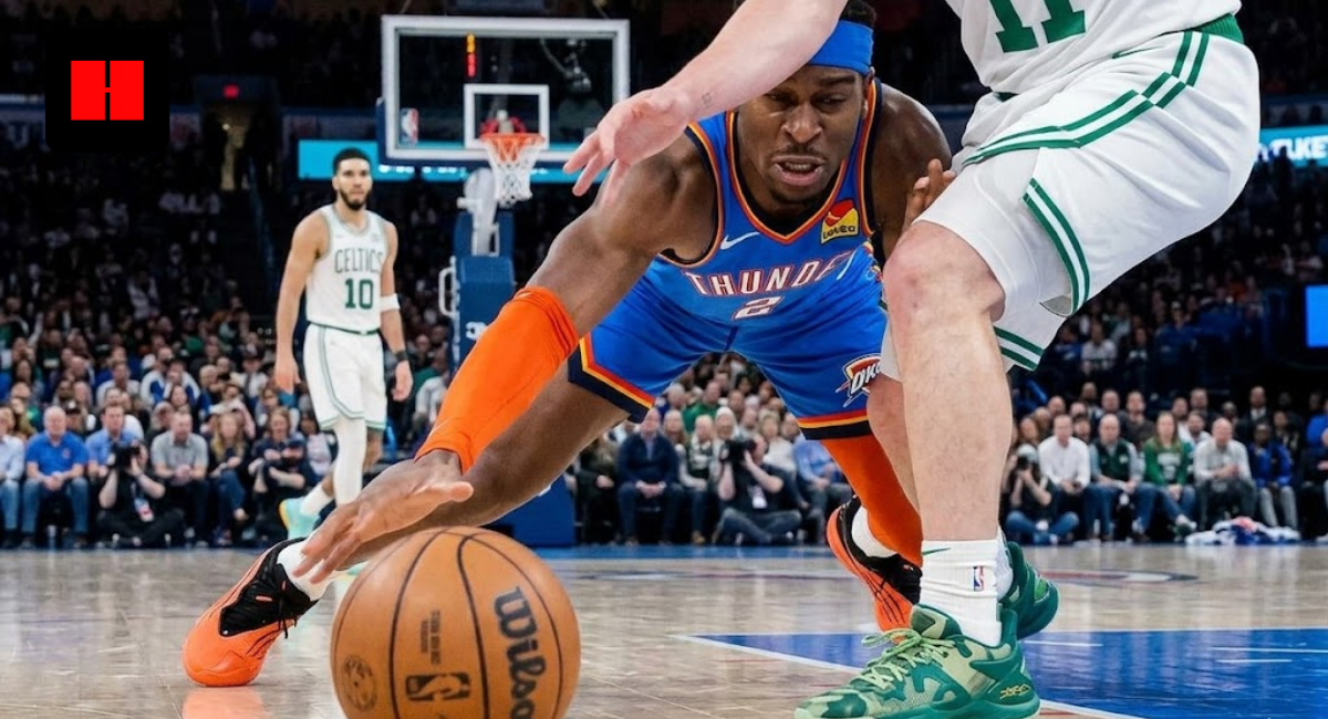 Low-angle floor cam photo of Shai Gilgeous-Alexander diving for a loose ball in the key against the Boston Celtics, highlighting his Converse sneakers.
