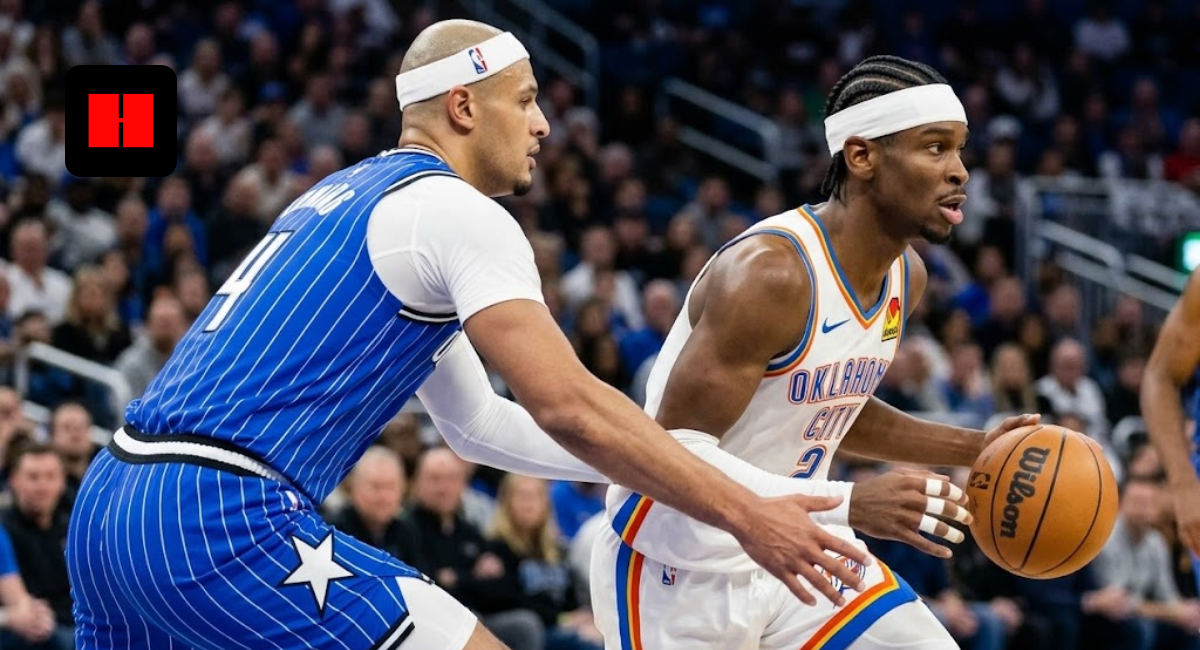 Shai Gilgeous-Alexander of the Oklahoma City Thunder dribbles the basketball while being guarded by Jalen Suggs of the Orlando Magic during an NBA game