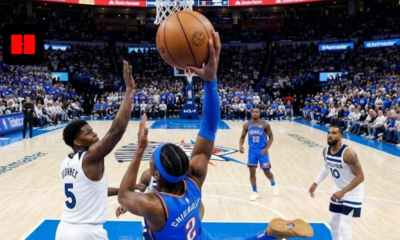 Shai Gilgeous-Alexander of the OKC Thunder driving for a layup against Anthony Edwards and Mike Conley of the Minnesota Timberwolves during a playoff game.