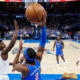 Shai Gilgeous-Alexander of the OKC Thunder driving for a layup against Anthony Edwards and Mike Conley of the Minnesota Timberwolves during a playoff game.