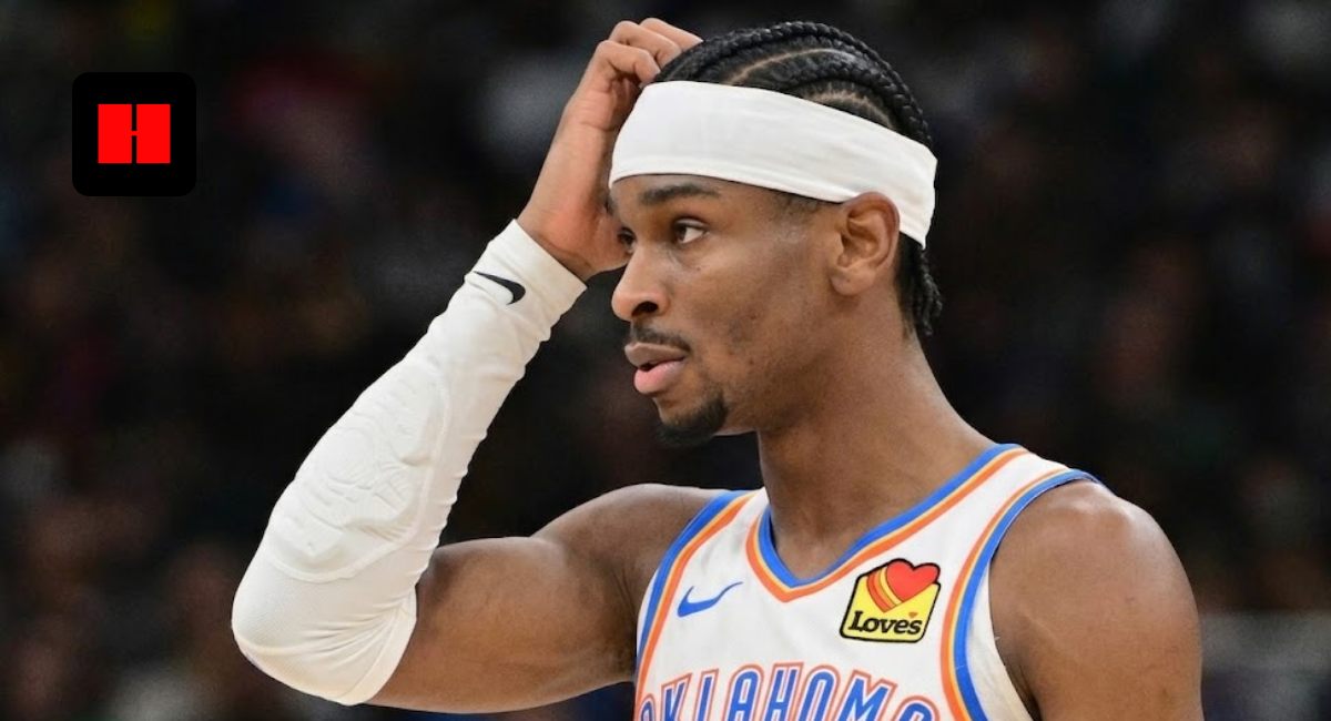 Shai Gilgeous-Alexander of the Oklahoma City Thunder wearing a white home jersey and headband, looking thoughtful on the court.