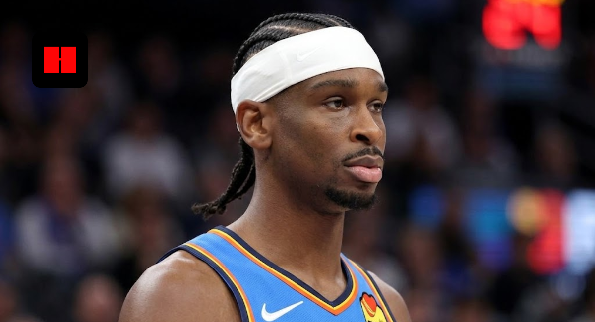 Close-up portrait of Shai Gilgeous-Alexander wearing a blue Oklahoma City Thunder jersey and white headband during a game.