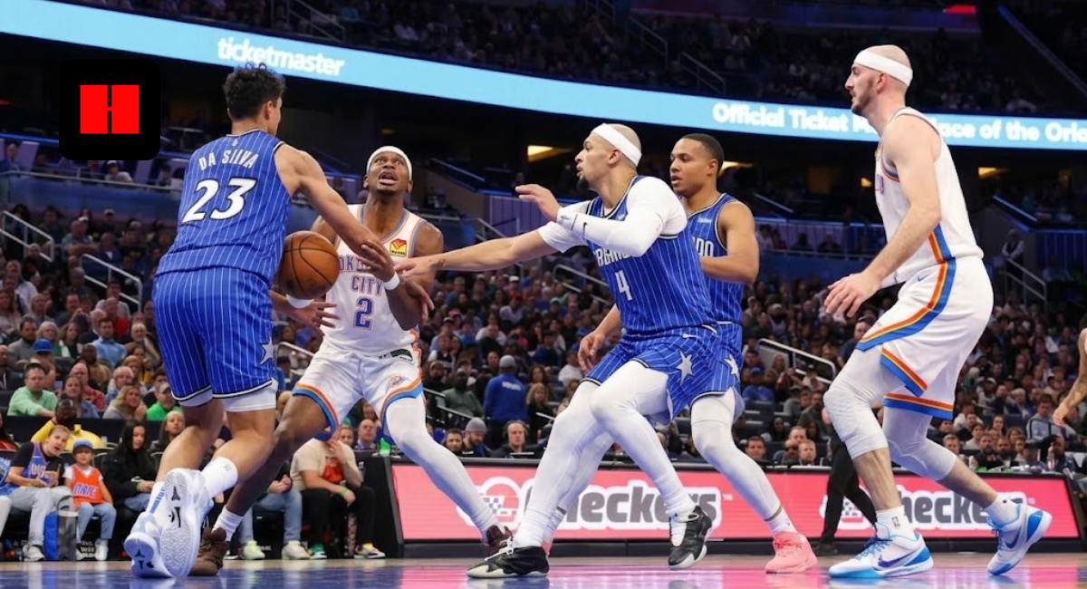 Shai Gilgeous-Alexander of the OKC Thunder driving to the hoop against Tristan da Silva and Orlando Magic defenders during an NBA game.