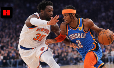 Shai Gilgeous-Alexander dribbling past Julius Randle during an NBA game with intense defense and action moment