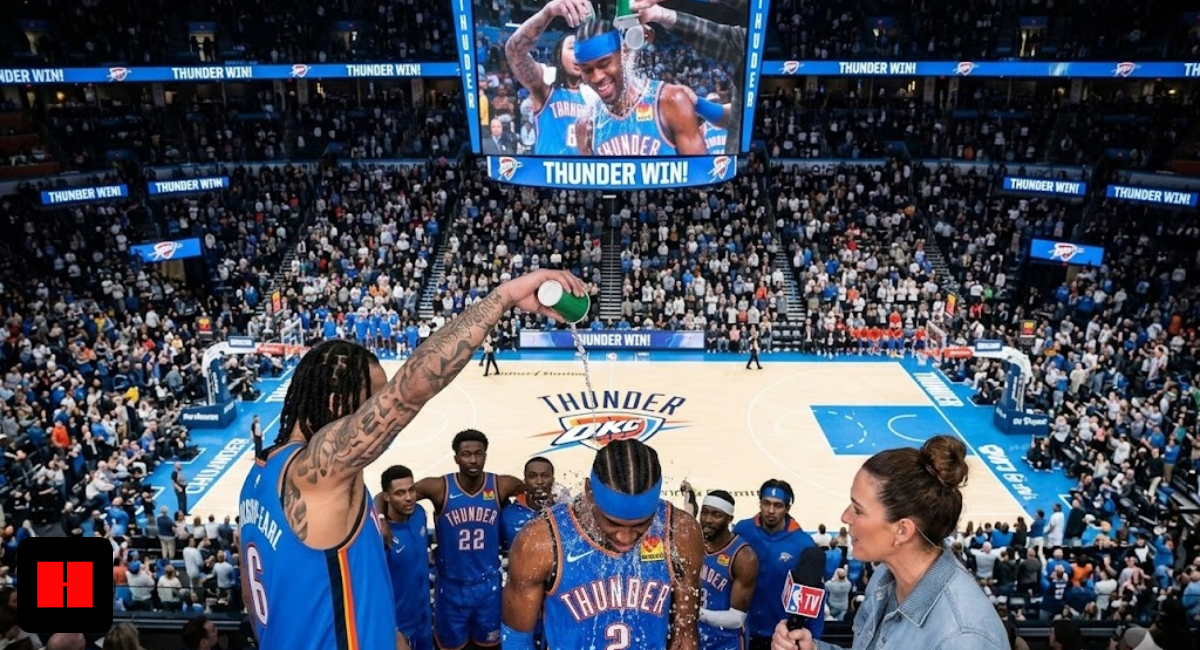 Shai Gilgeous-Alexander getting a water bath celebration from teammate Jeremiah Robinson-Earl on the OKC Thunder court after a win.