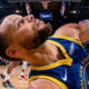 Stephen Curry reacting on court during a Golden State Warriors game, close-up angle highlighting knee injury concern and game intensity in 2026 season