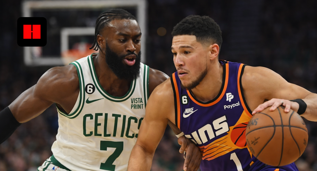 Phoenix Suns guard Devin Booker driving the ball against Boston Celtics forward Jaylen Brown in an NBA game.