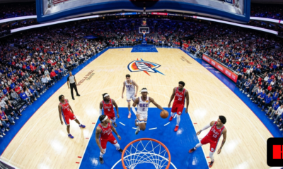 Oklahoma City Thunder guard drives for a fastbreak layup against Philadelphia 76ers defenders during a packed arena game in 2026