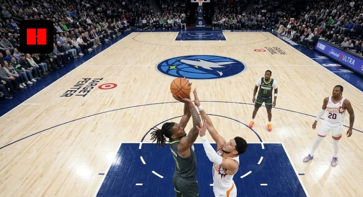 Minnesota Timberwolves player attempts contested layup over Phoenix Suns defender during NBA game at Target Center.