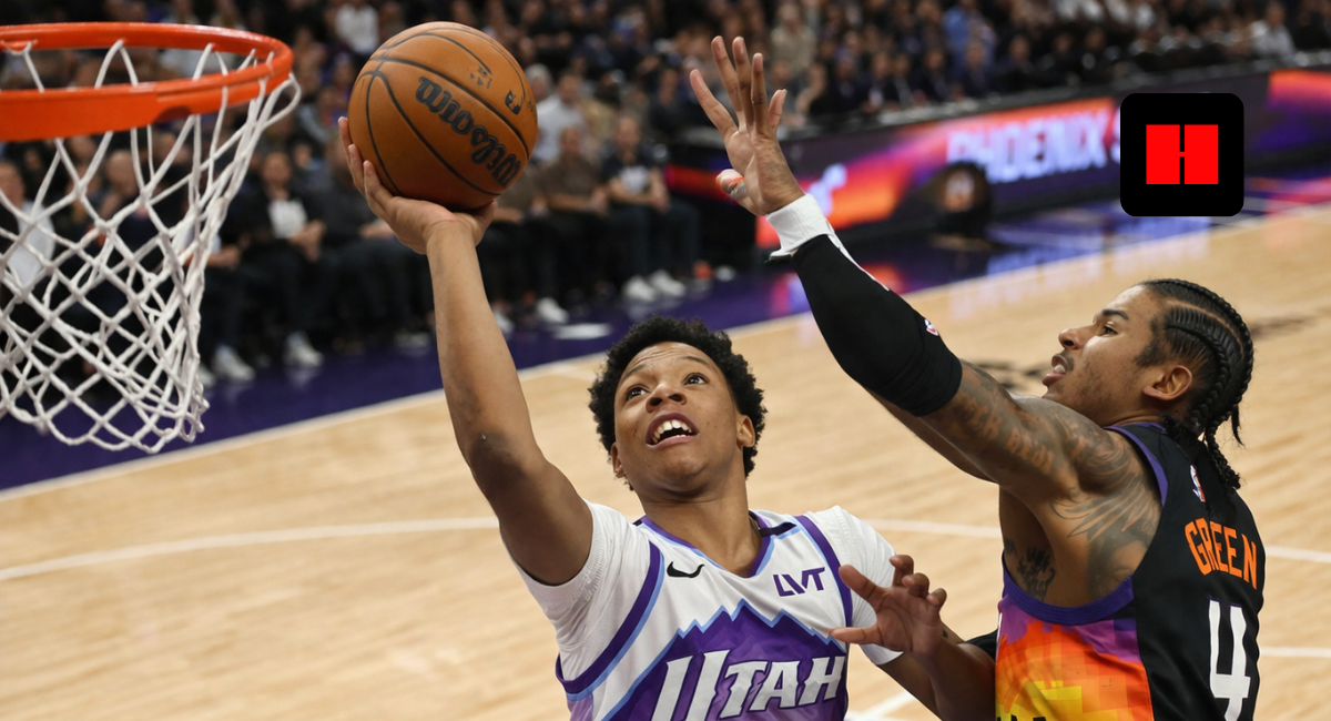 Utah Jazz player attempting a layup while Phoenix Suns defender contests the shot during an NBA game