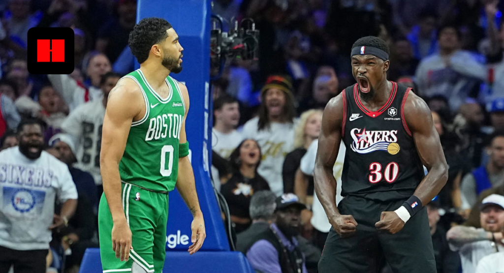 Philadelphia 76ers' Guerschon Yabusele in a black jersey flexes and shouts in celebration next to a focused Jayson Tatum in a green Boston Celtics jersey during a game.