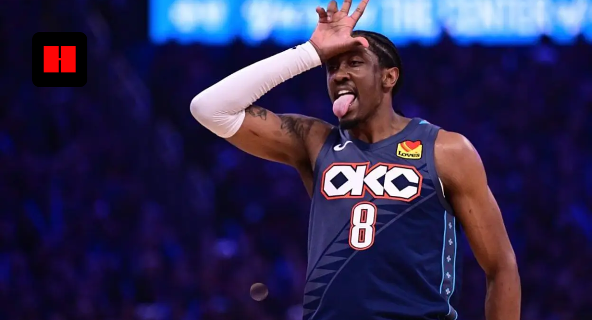 Oklahoma City Thunder forward Jalen Williams celebrating on court, wearing a navy blue City Edition jersey and white arm sleeve while making a playful "L" hand gesture and tongue-out expression.