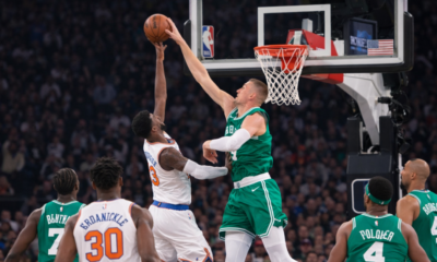 Low angle UHD shot of basketball player attempting a block during intense NBA game action near the hoop