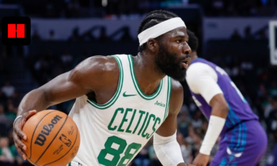 Close-up side profile of a Boston Celtics basketball player with a white headband dribbling a Wilson basketball during a game.