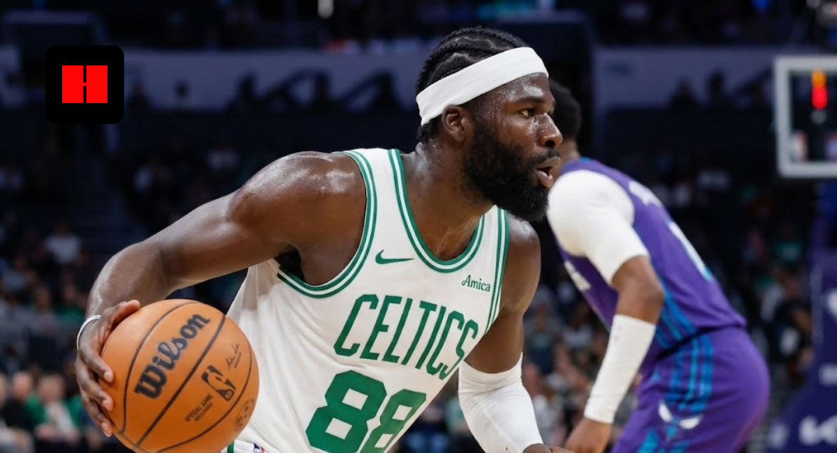 Close-up side profile of a Boston Celtics basketball player with a white headband dribbling a Wilson basketball during a game.