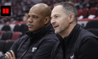 Chicago Bulls coaches sitting on bench during basketball game in side angle photo