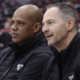 Chicago Bulls coaches sitting on bench during basketball game in side angle photo