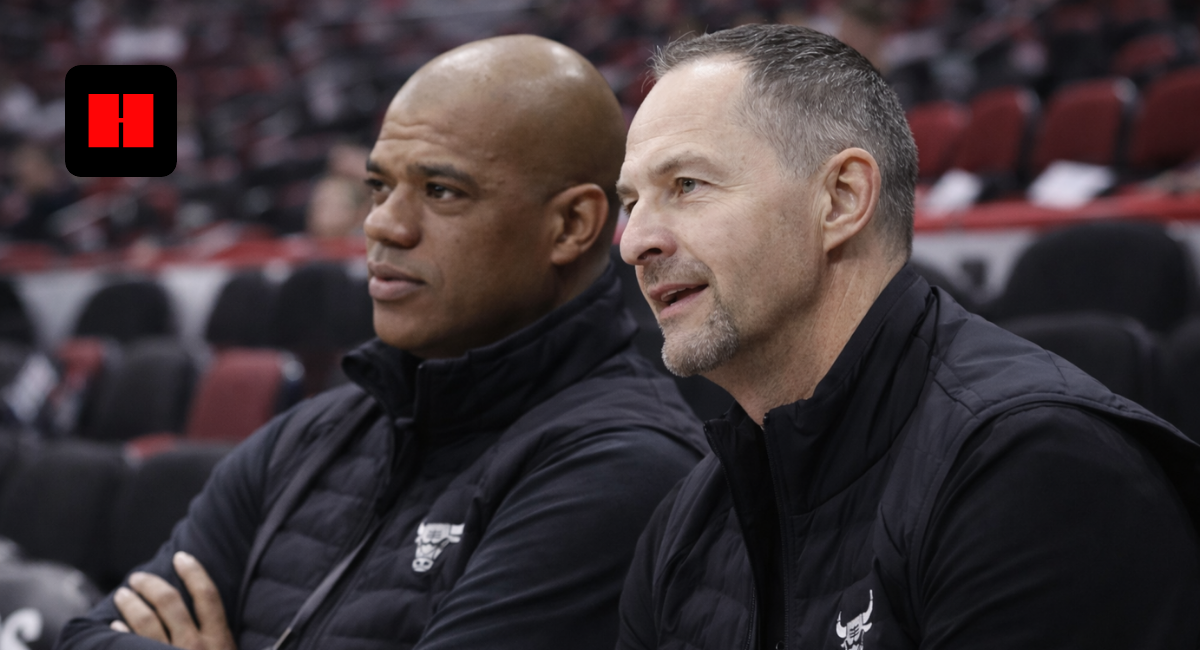 Chicago Bulls coaches sitting on bench during basketball game in side angle photo