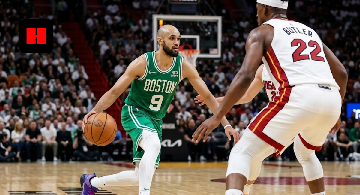 Boston Celtics guard Derrick White dribbling a basketball while being defended by Miami Heat's Jimmy Butler during an NBA game.
