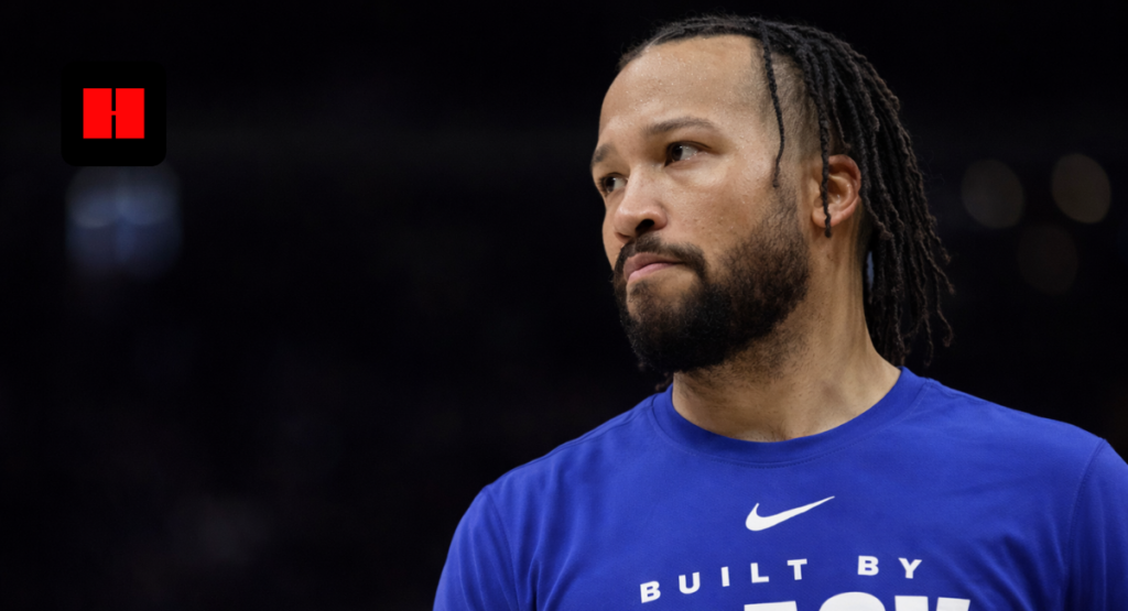 Jalen Brunson side angle portrait wearing blue Built By Black shirt in indoor arena