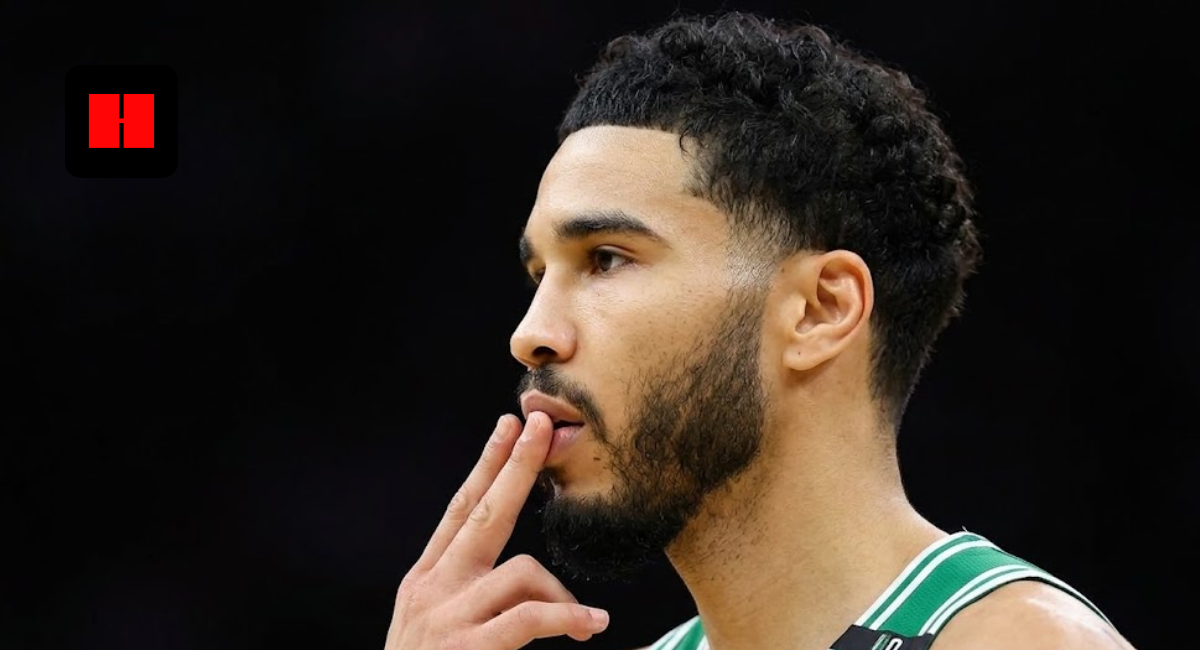 Jayson Tatum of the Boston Celtics in a side profile view on the basketball court, wearing a green and white jersey with fingers to his lips.