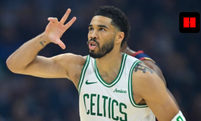 Boston Celtics forward Jayson Tatum (0) celebrating after making a three-point shot in a white Celtics jersey.