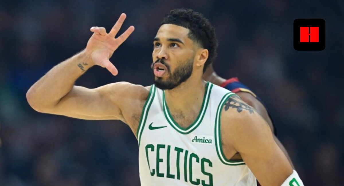 Boston Celtics forward Jayson Tatum (0) celebrating after making a three-point shot in a white Celtics jersey.