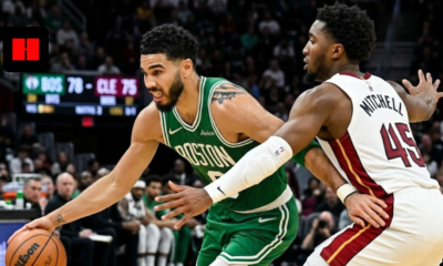 Jayson Tatum of the Boston Celtics driving to the basket while being guarded by Donovan Mitchell of the Cleveland Cavaliers during an NBA game.
