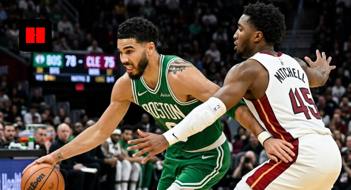 Jayson Tatum of the Boston Celtics driving to the basket while being guarded by Donovan Mitchell of the Cleveland Cavaliers during an NBA game.