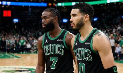 Jayson Tatum and Jaylen Brown standing together on the court in black Boston Celtics jerseys during an NBA game.