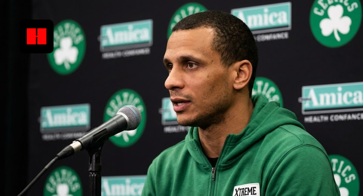 Boston Celtics head coach Joe Mazzulla speaking into a microphone during a press conference with Amica and Celtics logos in the background.