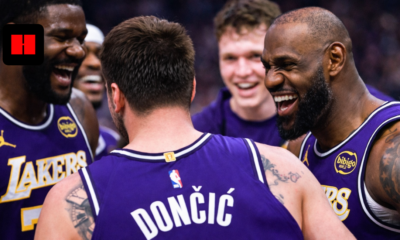 UHD side angle shot of Los Angeles Lakers players celebrating together during an NBA game with purple jerseys
