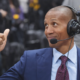 NBA commentator wearing a headset analyzing the game courtside