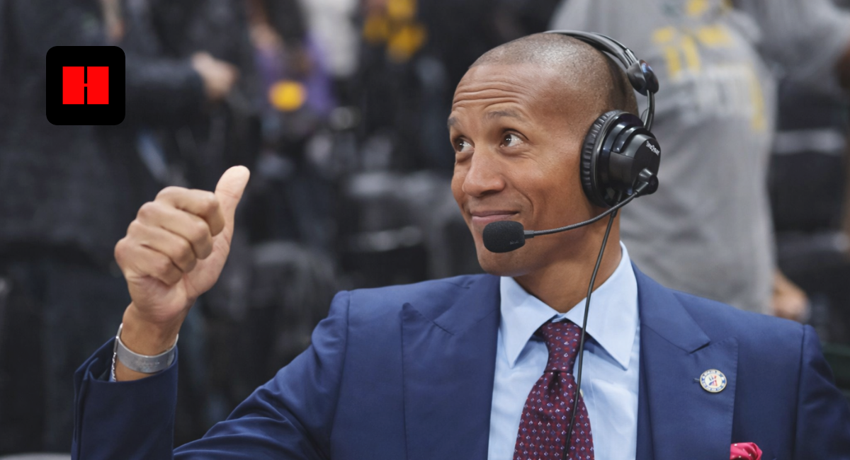 NBA commentator wearing a headset analyzing the game courtside