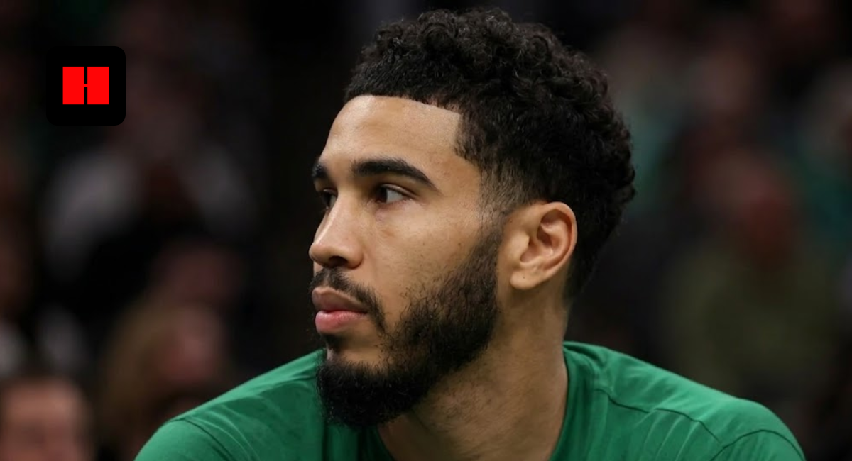 Profile shot of Jayson Tatum looking away, wearing a green Boston Celtics uniform with sponsorship logos