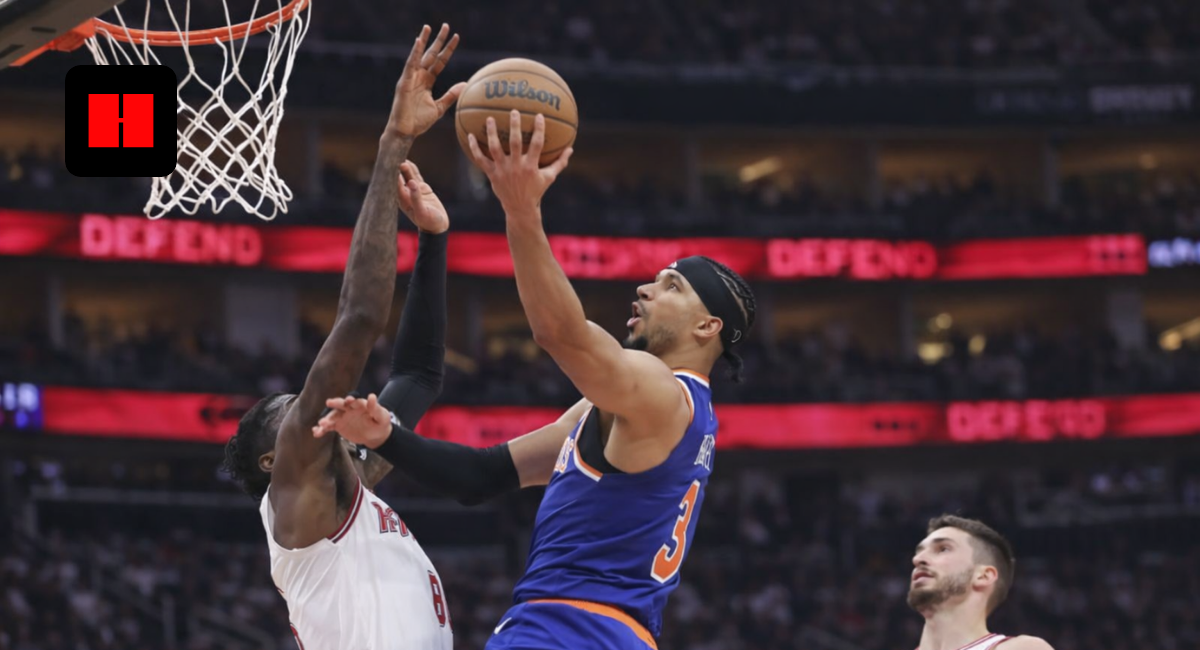 New York Knicks player attempts a layup while Houston Rockets defender tries to block during NBA game