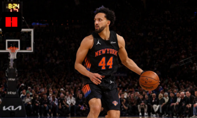 New York Knicks player dribbling the basketball during an NBA game on indoor court