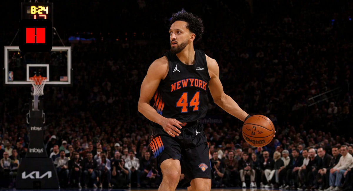 New York Knicks player dribbling the basketball during an NBA game on indoor court