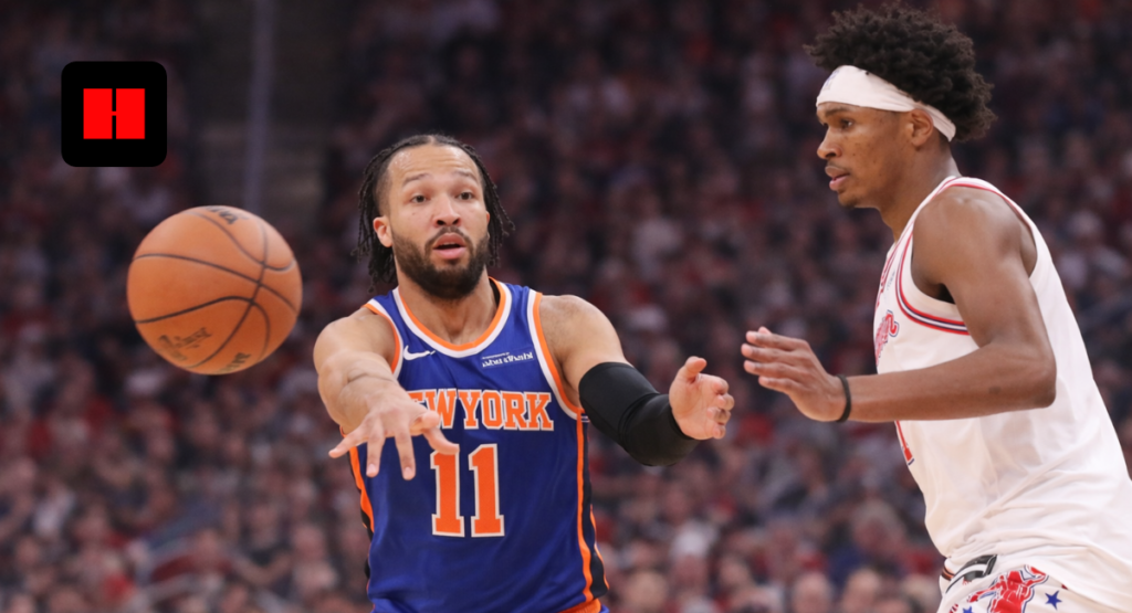 New York Knicks player passing the basketball while defended during an NBA game