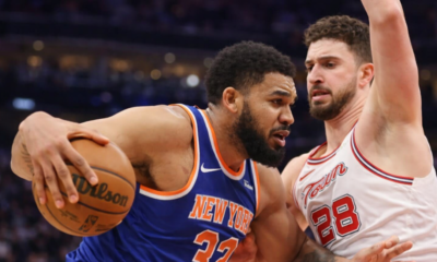 New York basketball player drives past defender during an intense game action moment