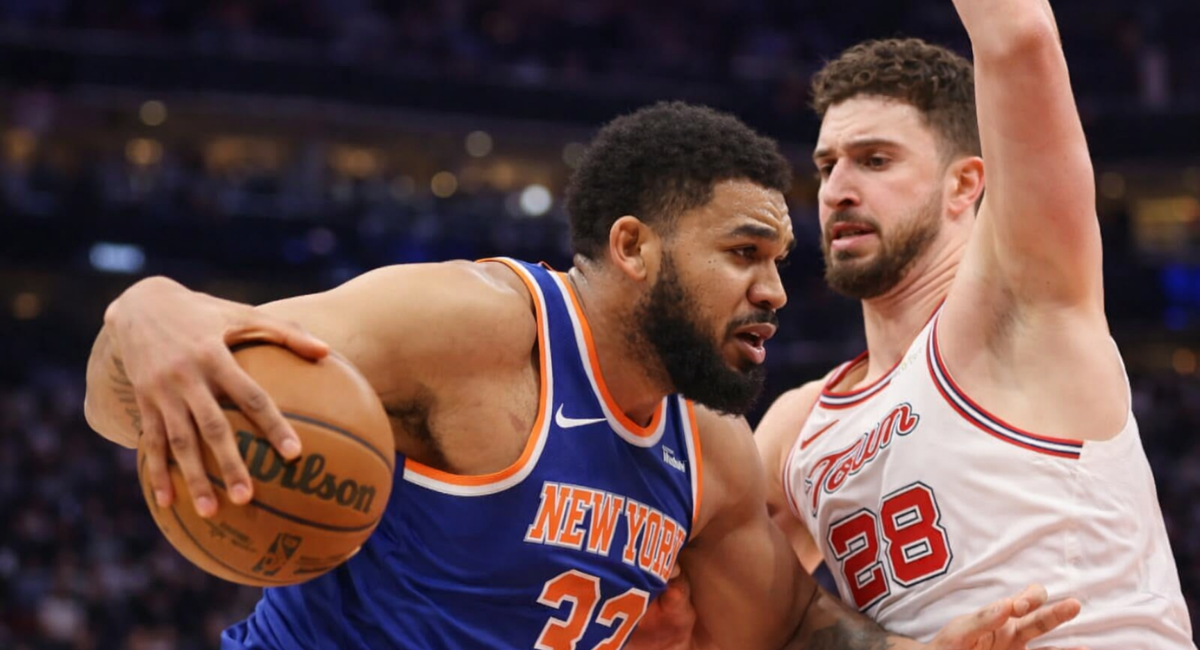 New York basketball player drives past defender during an intense game action moment