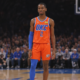 Oklahoma City Thunder basketball player standing on court during NBA game with arena background and new camera angle view