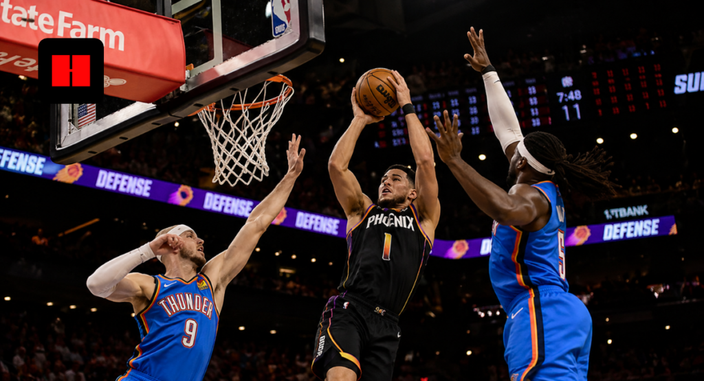 Devin Booker of the Phoenix Suns attempts a contested layup against Oklahoma City Thunder defenders during an NBA Playoffs game in 2026