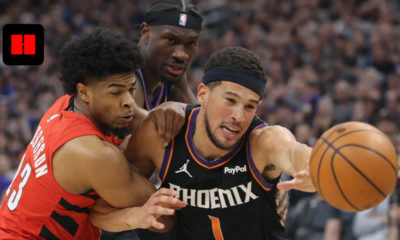 Devin Booker driving to the basket while being defended during a Phoenix Suns vs Portland Trail Blazers NBA game