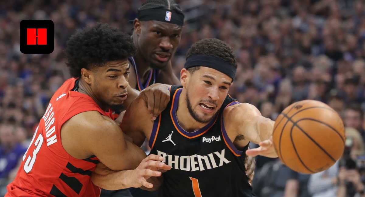 Devin Booker driving to the basket while being defended during a Phoenix Suns vs Portland Trail Blazers NBA game
