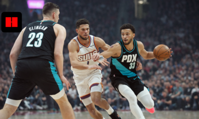 Portland Trail Blazers player dribbling past Phoenix Suns defender during an intense NBA game moment