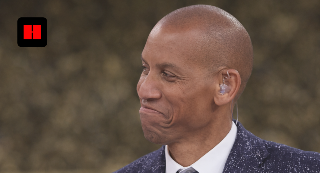 Reggie Miller side profile during NBA broadcast wearing navy suit and tie