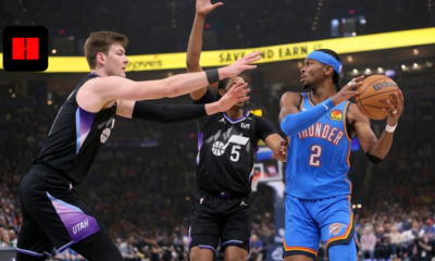Shai Gilgeous-Alexander of the OKC Thunder driving past Utah Jazz defenders in a professional basketball game.