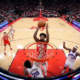 Tari Eason rises for a powerful dunk at the rim during a Houston Rockets game as defenders contest underneath