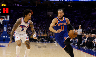 New York Knicks guard Jalen Brunson drives past Philadelphia 76ers forward Kelly Oubre Jr during an NBA game at Wells Fargo Center.